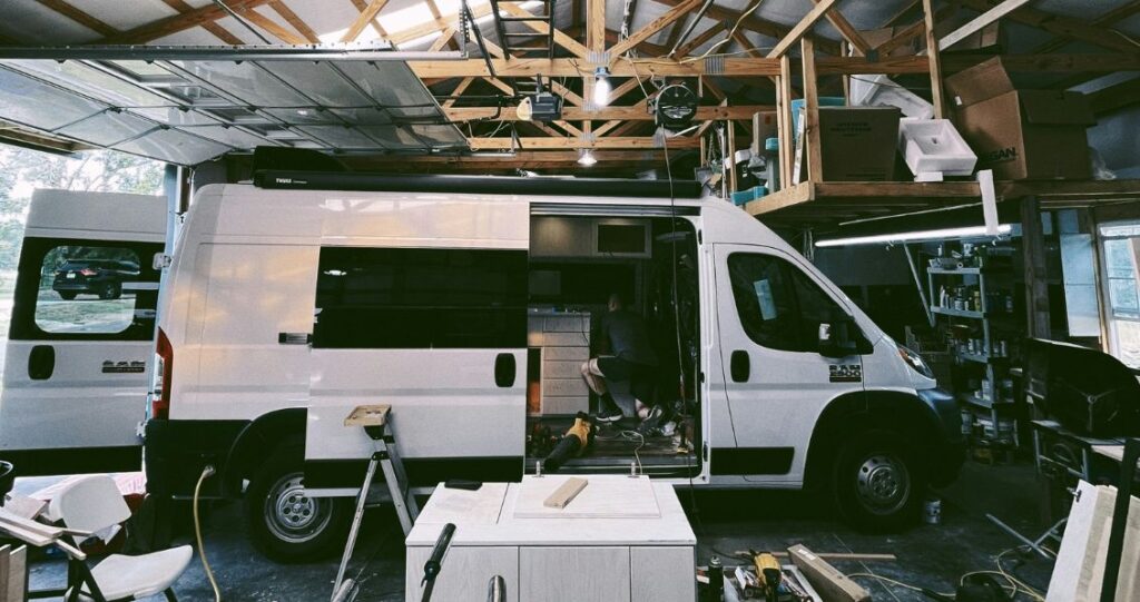 Image of a man building the interior of a camper van