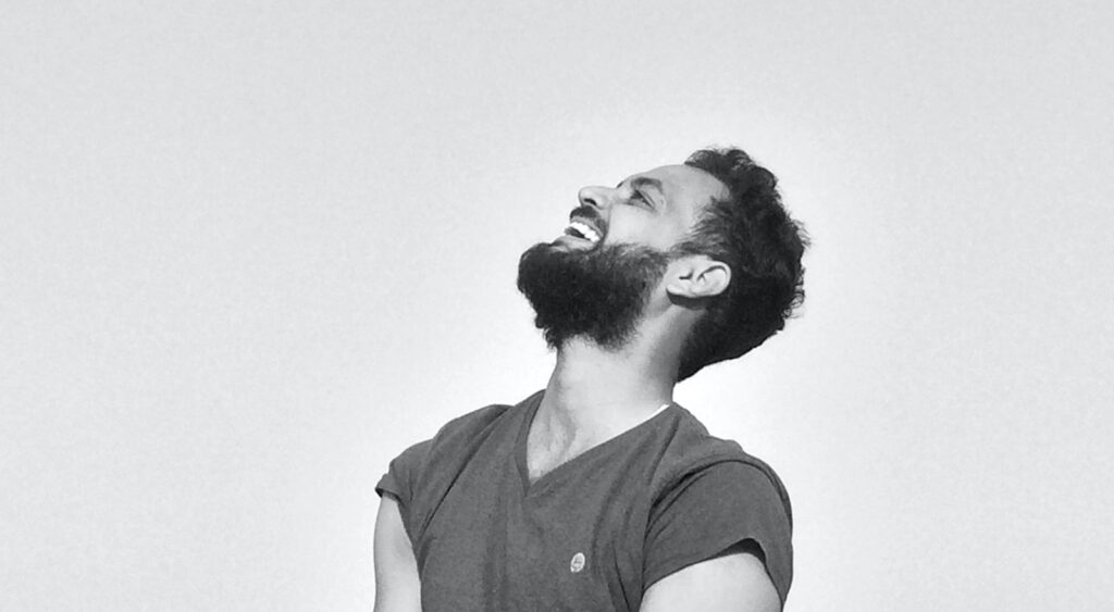 Happy bearded man smiling in black and white