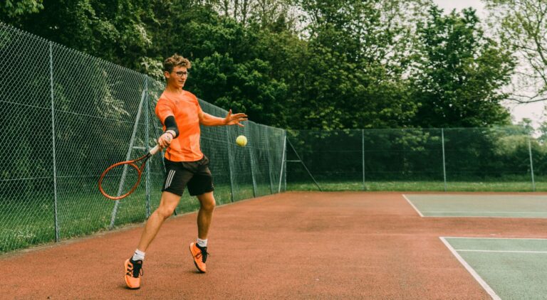 Beginner tennis player learning how to hit a forehand