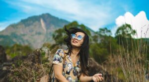 Happy woman sitting in the mountains